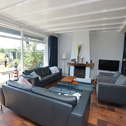 Lichte woonkamer met uitzicht op de natuur bij Orchismient 45 groot, vakantiehuis in De Koog, Texel.