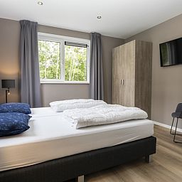 Comfortabele slaapkamer in Villa 17, De Koog, Texel, vakantiehuis met uitzicht op de natuur van de Waddeneilanden.