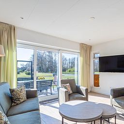Bright living room in Orchismient 14 vacation home, De Koog Texel with comfortable seating area.