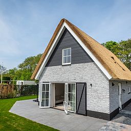 Rueckseite der Villa 25b in De Koog, Texel mit Fluegeltueren zum Wattenmeer-Garten.