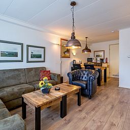 Stijlvolle binnenruimte van Appartementen Anna - de Zeehond, De Koog, Texel met houten meubels en sfeervolle decoratie.