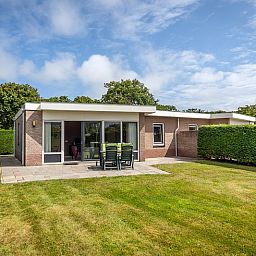 Vacation home Bungalow 31 in De Koog, Texel with sunny terrace and green surroundings.