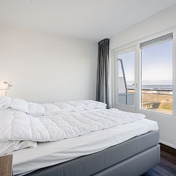 Slaapkamer met panoramisch uitzicht in Appartement Juliana 154 Zeezicht, De Koog, Texel.