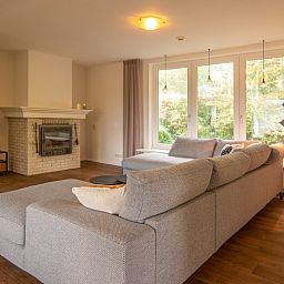 Spacious seating area overlooking the garden in Kamerstraat 66 vacation home in De Koog Texel.