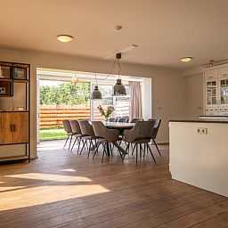 Dining room with large table and lots of light in Kamerstraat 66 vacation home in De Koog Texel.