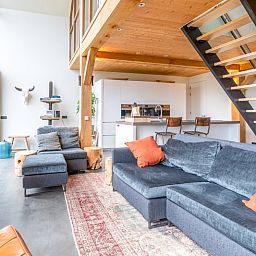 Modern kitchen and comfortable sitting area in Villa 191 with Hottub, De Koog, Texel, perfect for relaxation.