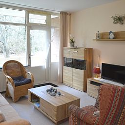 Helles Wohnzimmer im Apartment Kerckeland 68, De Koog, Texel mit Blick auf die gruene Umgebung.
