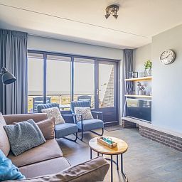 Stijlvolle zithoek in Appartement Juliana 156 Zeezicht, De Koog, Texel, met grote ramen en uitzicht op de Wadden.