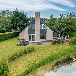Uitzicht op Vakantiehuis Kamperfoelie 71 in De Koog, Texel, met groene omgeving.
