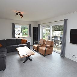 Gemuetliches Wohnzimmer des Ferienhauses Stappeland 203 in De Koog, Texel mit bequemer Sitzecke.