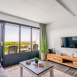 Bright living room in Apartment Juliana 094 Island and Sea View, De Koog, Texel with terrace and beautiful sea view.