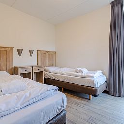 Slaapkamer in bungalow Schilpbanck 6, De Koog, Texel met comfortabele bedden en uitzicht op de natuur van de Waddeneilanden.