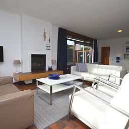 Cozy living room in Orchismient 18 large, De Koog, Texel with modern furnishings and fireplace.