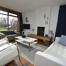 Bright living room in Orchismient 18 large, De Koog, Texel with large windows and elegant interior.