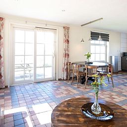 Cozy living room in Cottage in De Waal, Texel with lots of light and access to terrace.