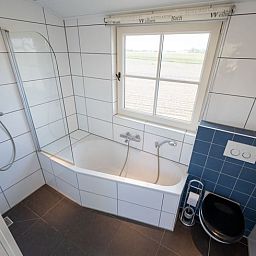 Modern bathroom with bathtub in vacation home Huisje in De Waal, Texel on the Wadden Islands.
