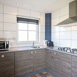 Fully equipped kitchen in Cottage in De Waal, Texel with modern appliances and views.