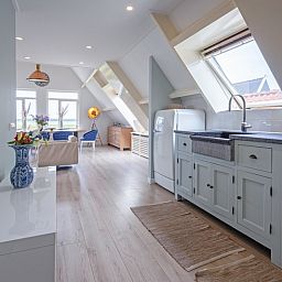 Stilvolle Kueche im Hotel Loodsmans Welvaren - Apartment, Den Hoorn, Texel mit hellen und modernen Geraeten.