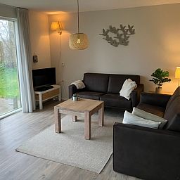 Stylish living room of Type I - No. 89 Lark, vacation home in Oosterend, Texel, with comfortable seating area.