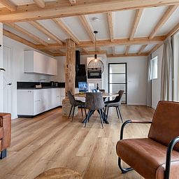 Open kitchen and dining area in Apartment C, Oudeschild, with modern amenities.