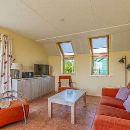 Cozy living room in The Five Star Holiday Home South Eierland Texel with comfortable seating.