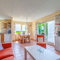 Open kitchen and dining area of The Five Star Holiday Home in South Eierland Texel overlooking nature.