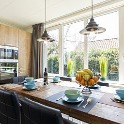 Dining room of Duunkruud in Zuid-Eierland, Texel, overlooking the garden.