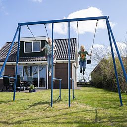 Children play on swing at Duunkruud in South Eierland, Texel.