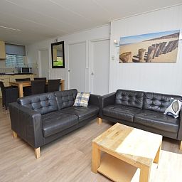 Open woonkamer en keuken in Vakantiehuis de Parel 282, De Dennen, Texel met moderne inrichting.