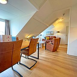 Dining room with wooden table in Apartment Bos en Duin 34, De Dennen, Texel.