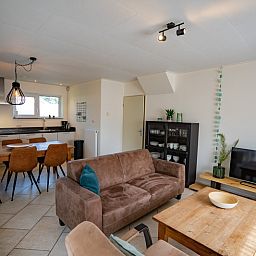 Cozy living room of Holiday Home 't Hoogelandt 136A in De Dennen, Texel with modern furnishings.
