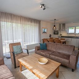 Bright living room of Holiday Home 't Hoogelandt 136A in De Dennen, Texel overlooking the garden.
