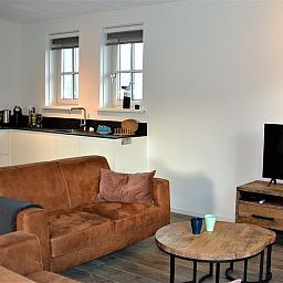 Luxurious open kitchen and lounge in Golden Raand vacation home, Texel.