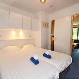 Comfortable bedroom in Apartment Amelander-Kaap TIME-OUT with SWIMMING POOL, Hollum, Ameland, ideal for a relaxing stay.