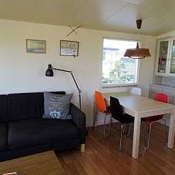 Bright living room of De Doorloper chalet in Midsland Noord, Terschelling with modern decor on the Wadden Islands.