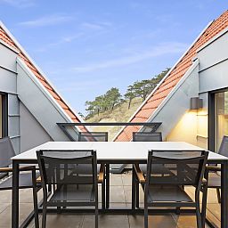 Cozy dining table in 6-person penthouse 6LP, West-Terschelling, Wadden Islands overlooking nature.