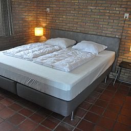Comfortable bedroom in Jans bungalow, Ballum, Ameland, with double bed and mood lighting.