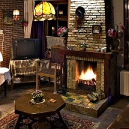 Cozy living room with fireplace in vacation home Suzan, Ballum, Ameland, a warm place in the Wadden Islands.