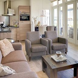 Helles Wohnzimmer der Boomhiemke Haeuser in Hollum, Ameland mit Blick auf die Terrasse.