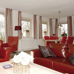 Cozy living room of WEIDEVILLA B 6 in Hollum, Ameland, with comfortable sitting area and dining area.