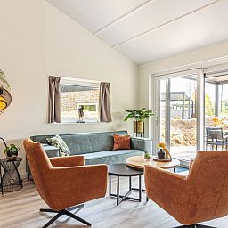 Cozy living room of Nesserduinen 42D, vacation home in Nes, Ameland with comfortable seating area.