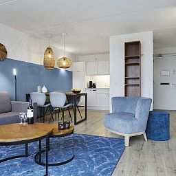 Detail of the cozy sitting area in Ameland State apartment, Nes, Ameland, with decorative elements.