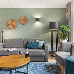 Wine and glasses on the table at Ameland State 4-person apartment in Nes, Ameland.