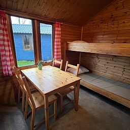 Cozy interior of Holiday Home in Workum with wooden interior, bunk bed and dining area, ideal for a stay at the IJsselmeer.