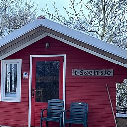 Charming vacation home in Workum with red facade, located near the IJsselmeer and Frisian lakes, ideal for a winter vacation.