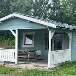 Vacation home in Workum, a charming vacation home on the IJsselmeer, offers an inviting veranda amid the Frisian lakes.