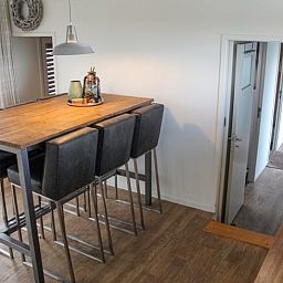 Stylish dining area in Holiday Home in Oudega, located on Lake Heeg in the Frisian Lakes, with modern decor and cozy atmosphere.
