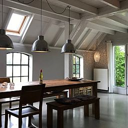 Spacious dining room in Holiday home in Kollumerpomp, Lauwersmeer, with large wooden table and lots of natural light.