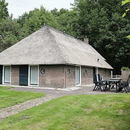 Spacious terrace at vacation home in Orvelte, Central Drenthe, ideal for outdoor meals.