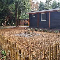 Snowy terrace of Holiday cottage in Gasselte, Drenthe, with serene winter nature and an inviting porch.